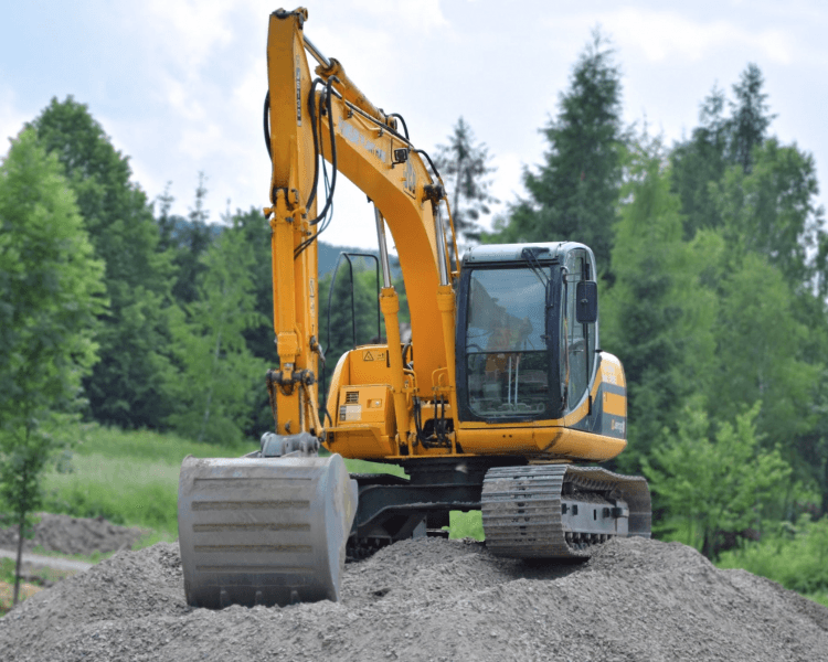 A tracked excavator working a cleared lot on a Snohomish County job site.